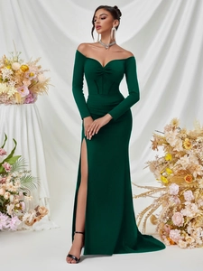 Elegant emerald green off-shoulder floor-length gown with long sleeves and side slit
