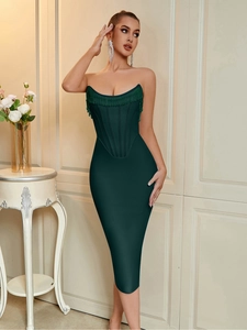 Close-up of green beaded fringe detail on the strapless bodice of a dark green evening dress