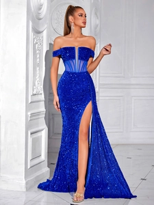Close-up of sparkling royal blue sequined fabric and mesh paneling on a luxury gown