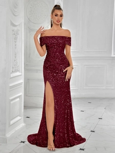Detailed view of shimmering sequins and thigh-high slit on a burgundy evening gown