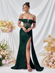 Detailed view of dark green sequin gown with off-shoulder cut and waist mesh structure