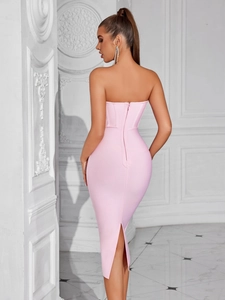 Back view detail of pink strapless bandage dress showing zipper and slit design