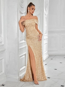 Close-up of champagne gold sequined fabric with high slit detail on evening gown