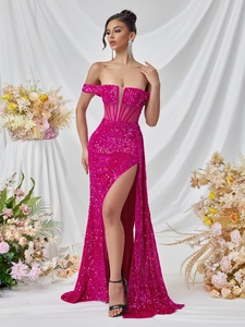 Detail view of fuchsia sequin dress featuring boned corset bodice and high side slit