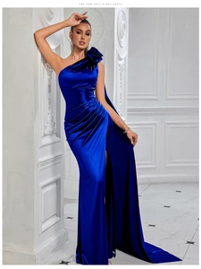 Detailed view of royal blue satin evening gown with 3D floral shoulder and waist pleats