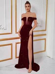 Detailed view of sequin evening dress featuring off-shoulder corset and high leg slit