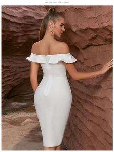 Close-up of white off-shoulder bandage dress with ruffle detail and back zipper closure