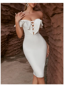 Close-up of white off-shoulder bandage dress with ruffle details and criss-cross laces