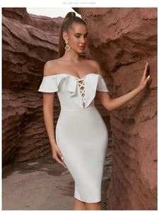 Detail of off-shoulder white bandage dress featuring ruffled neckline and lace-up front