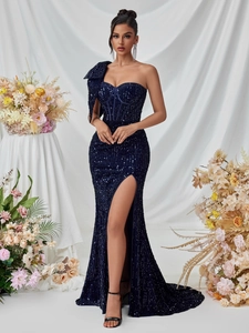 Detailed macro view of the sparkling sequin fabric and elegant high slit on this navy gown