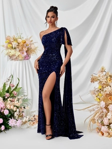 Detail showing deep blue sequined gown with one-shoulder cape and elegant high slit
