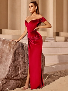 Detailed close-up of dark red velvet evening gown featuring a side slit and waist pleats
