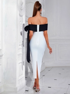 Détail du grand nœud papillon noir au dos de la robe bandage couleur ivoire