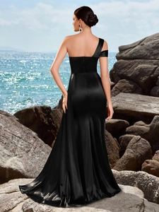 Back view of an elegant black satin one-shoulder evening gown with a high-slit and mermaid hem