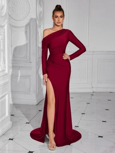 Detail view of the elegant burgundy evening gown with ruched side slit and asymmetric sleeve