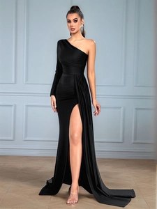 Detail of elegant black one-shoulder dress with high slit and draped pleats on waist