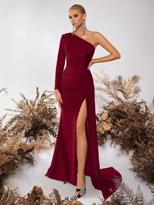 Detail of burgundy off-shoulder evening gown featuring high slit and pleated fabric texture