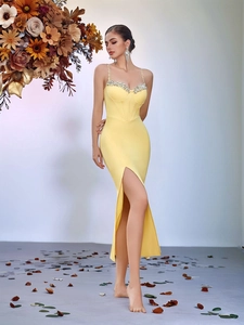 Detail showing crystal-embellished straps and cup structure on a yellow dress