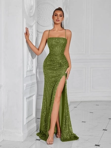Detail view of emerald green sequin evening gown featuring side slit and high waist fold
