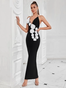 Close-up of 3D satin rose details and pearl straps on a black elegant backless dress