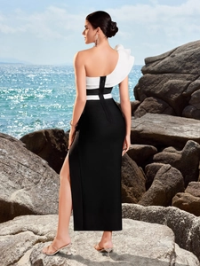 Elegant black and white contrast one-shoulder evening dress with side slit and ruffle detail