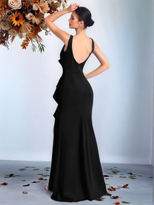 Detail of elegant black sleeveless evening dress featuring a deep U-back and side ruffles