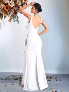 Detail showing the elegant backless design and layered ruffle side of the white evening gown
