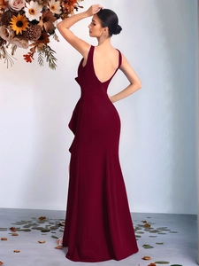 Detail of elegant backless design and ruching on a burgundy evening gown for women