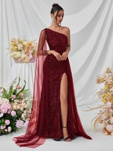 Detail view of burgundy sequined gown with one-shoulder design and mesh cape detail