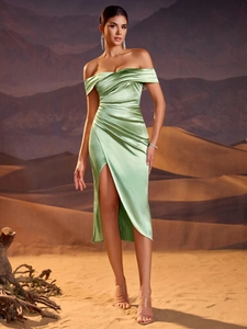 Close-up of mint green satin evening dress featuring elegant pleats and off-shoulder detail