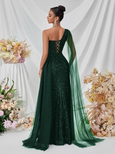 Close-up of elegant emerald green sequin gown with intricate lace-up back design