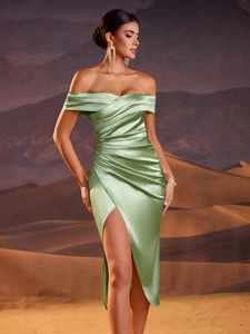 Close-up of grass green satin off-shoulder evening gown with elegant pleated details