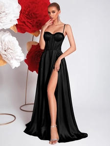 Detail of elegant black satin evening dress with corset bodice and high slit design