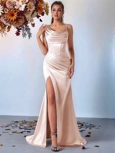 Detail view of champagne satin dress showing corset bodice and high slit elegant design