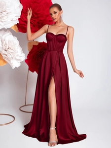 Detail of burgundy satin corset dress with fishbone boning and high slit design