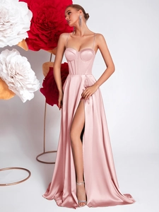 Detail of light pink satin evening gown featuring high slit and corset style bodice