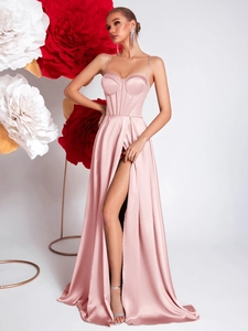 Detailed close-up of pink satin evening gown featuring corset bodice and high side slit