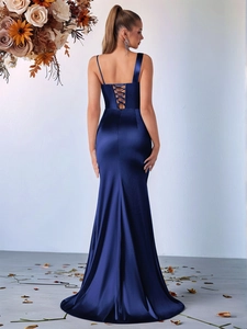 Rear view of navy blue satin mermaid dress featuring a lace-up back and asymmetric straps