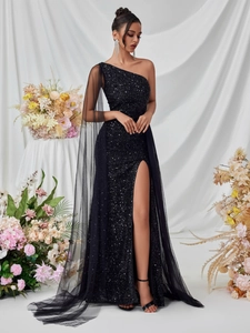 Elegant one-shoulder black sequin evening gown with a long mesh cape and high slit