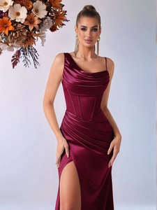 Detail of burgundy satin evening dress with asymmetrical neckline and corset waist