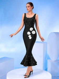 Detail of elegant white 3D rose flowers and pearl beading on a black bandage dress