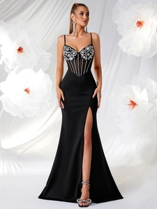 Close-up of black evening gown featuring intricate silver sequins and corset-style bodice