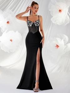 Detail of sheer corset bodice with floral embroidery on black split evening dress