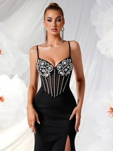 Detail of black evening dress featuring rhinestone floral accents and sheer corset mesh