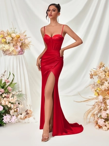 Detailed view of red satin evening gown featuring corset bodice and high slit design