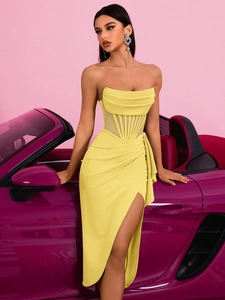 Detail of elegant yellow off-shoulder corset dress with high slit and draped fabric