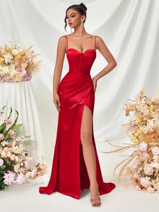 Detailed view of red satin evening gown featuring an elegant side slit and ruched texture