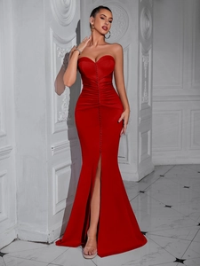 Detailed view of the red strapless gown featuring decorative buttons and a high leg slit