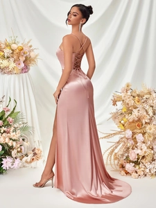 Detail of rose pink satin evening dress featuring crisscross back ties and a high side slit