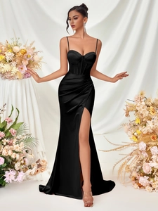 Detail of elegant black satin evening dress showing corset bodice and high side slit
